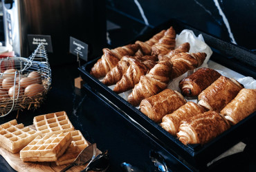 Delicious breakfast at the Appart’City Paris Vélizy aparthotel, featuring pastries, waffles, and fresh eggs